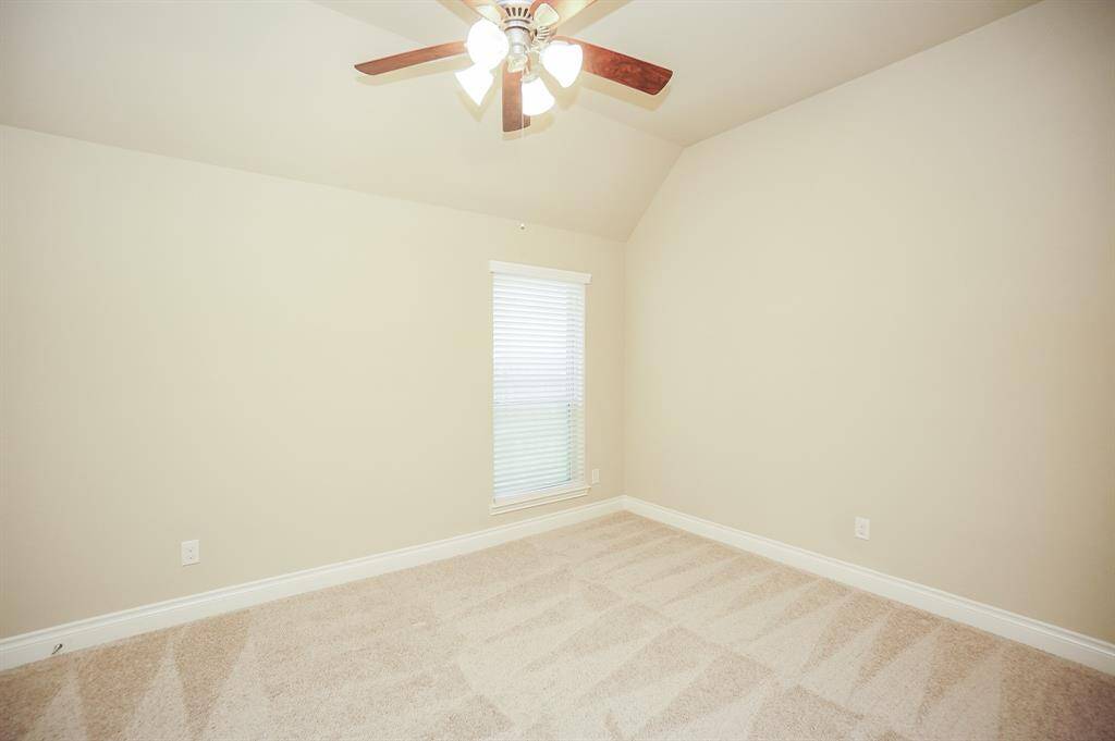Light walls and new carpeting are naturally lit by this super large window.