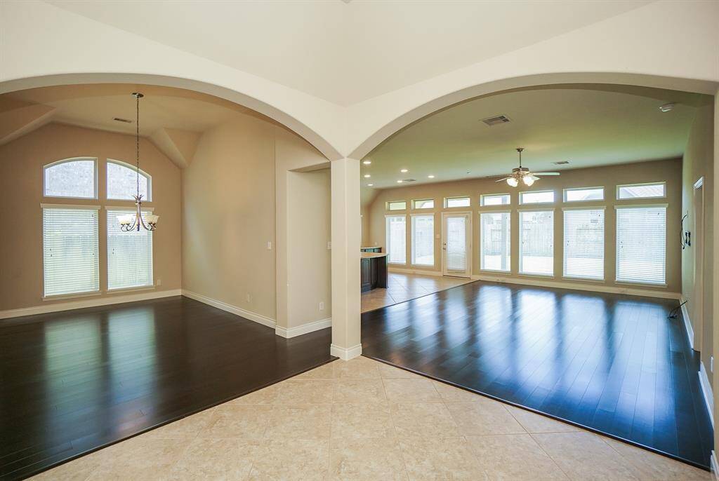 Worlds of space open up, courtesy of the open floor plan design concept, in expansive blended living/dining/kitchen space.