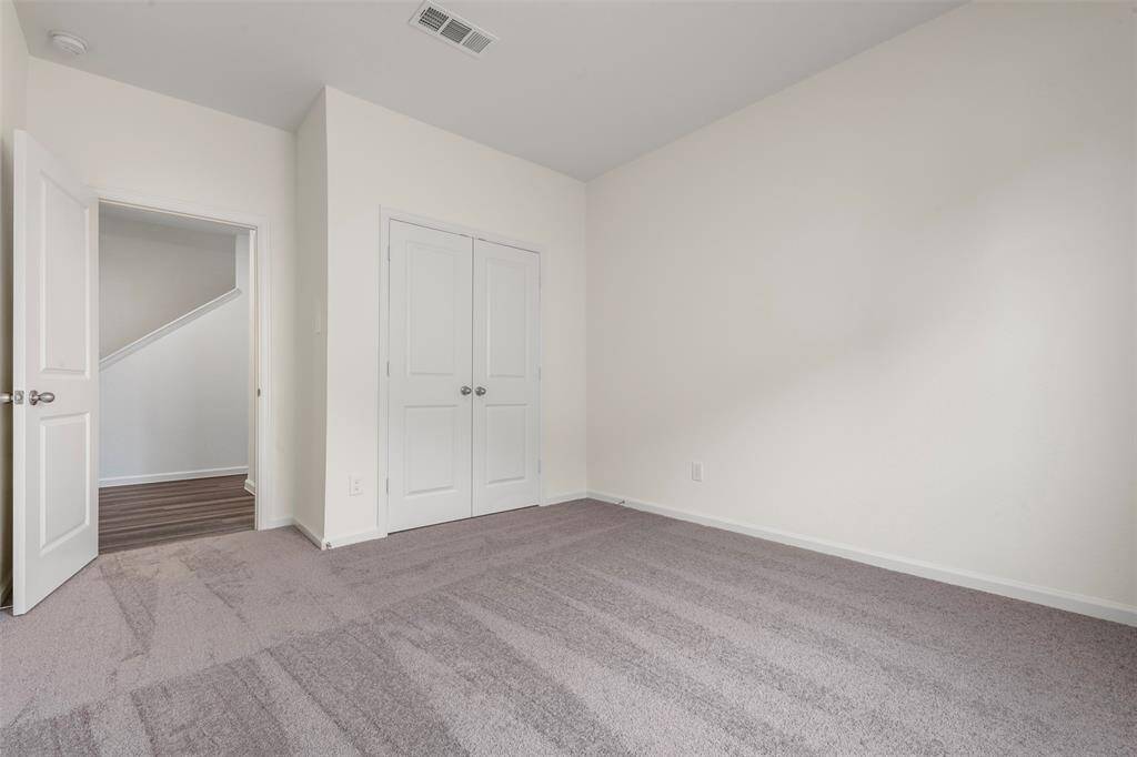 A spacious upstairs primary bedroom offering a luxurious en suite bathroom with dual vanities, a soaking tub, separate shower, and a generous walk-in closet.