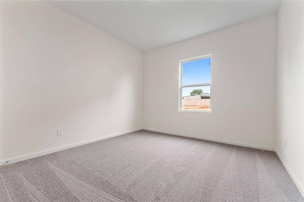 A spacious upstairs primary bedroom offering a luxurious en suite bathroom with dual vanities, a soaking tub, separate shower, and a generous walk-in closet.