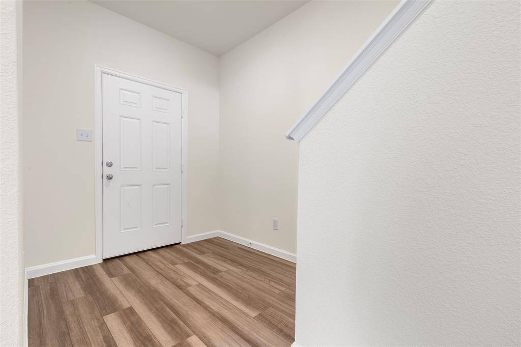 A conveniently located bedroom on the main floor, perfect for guests or multi-generational living, accompanied by a full bathroom featuring contemporary fixtures.