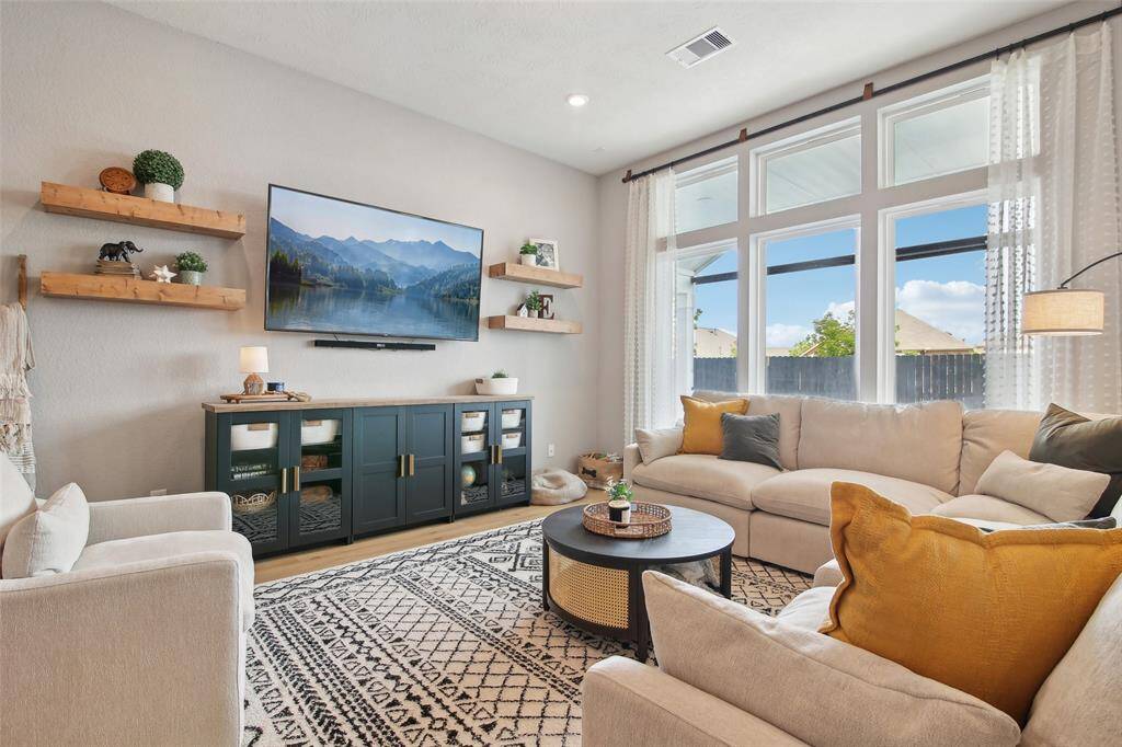 Perfect for entertaining or everyday lounging, the seamless flow to the kitchen and dining area makes it both functional and stylish.