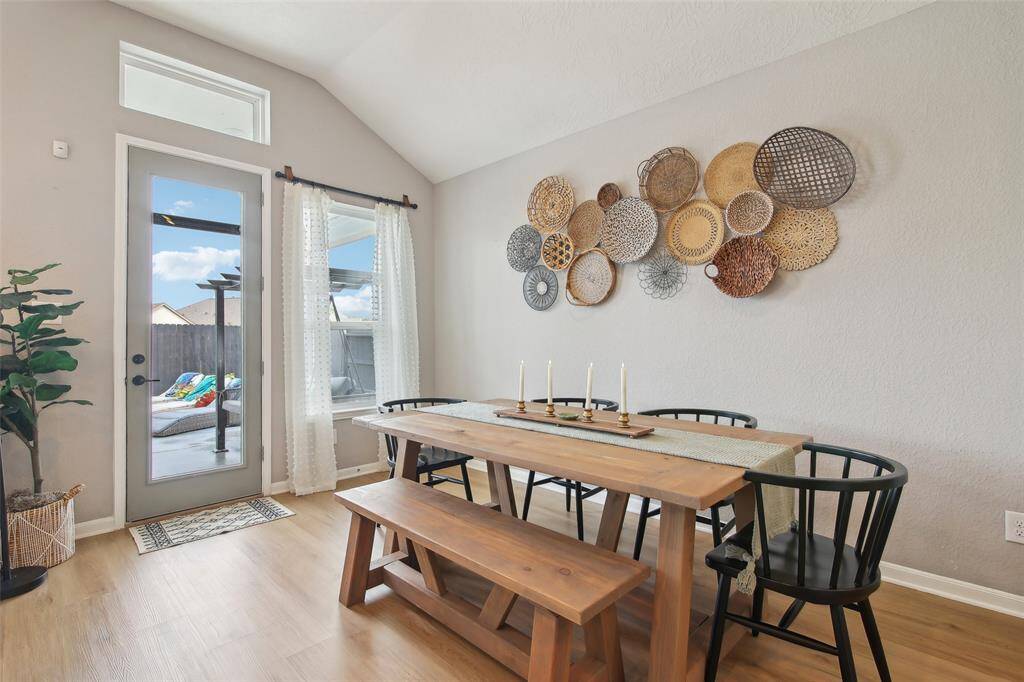 The dining space blends effortlessly between the kitchen and living room, offering a designated area for meals without sacrificing openness.
