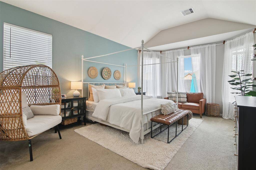 The expansive downstairs primary bedroom includes a private sitting area ideal for relaxing with a book or morning coffee.
