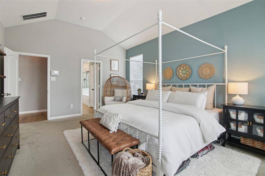 Large windows overlook the tranquil backyard, filling the space with natural light and peaceful views.