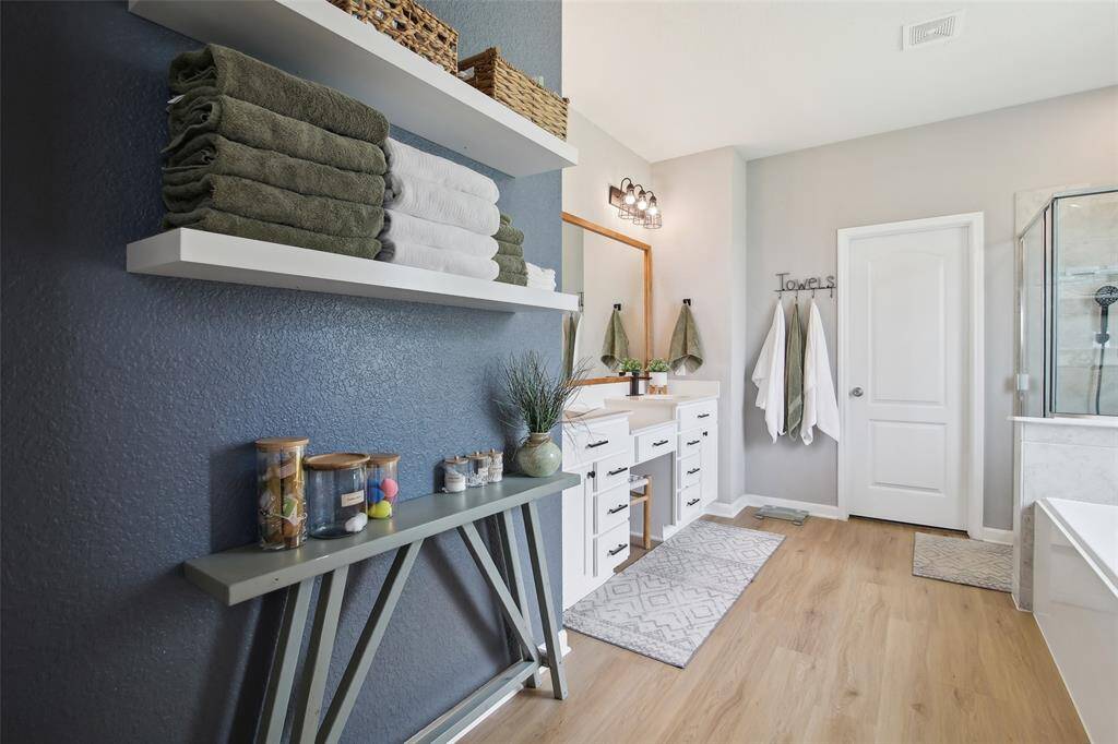 The primary bathroom is a luxurious retreat featuring a deep soaking tub and a separate walk-in shower for ultimate relaxation.