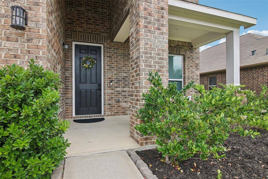 Covered front porch provides a warm welcome — perfect for greeting guests or enjoying morning coffee.