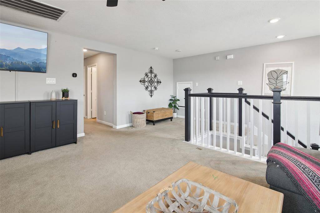 As you head upstairs, the spacious gameroom is located on the right, offering a large open area perfect for entertainment and relaxation.