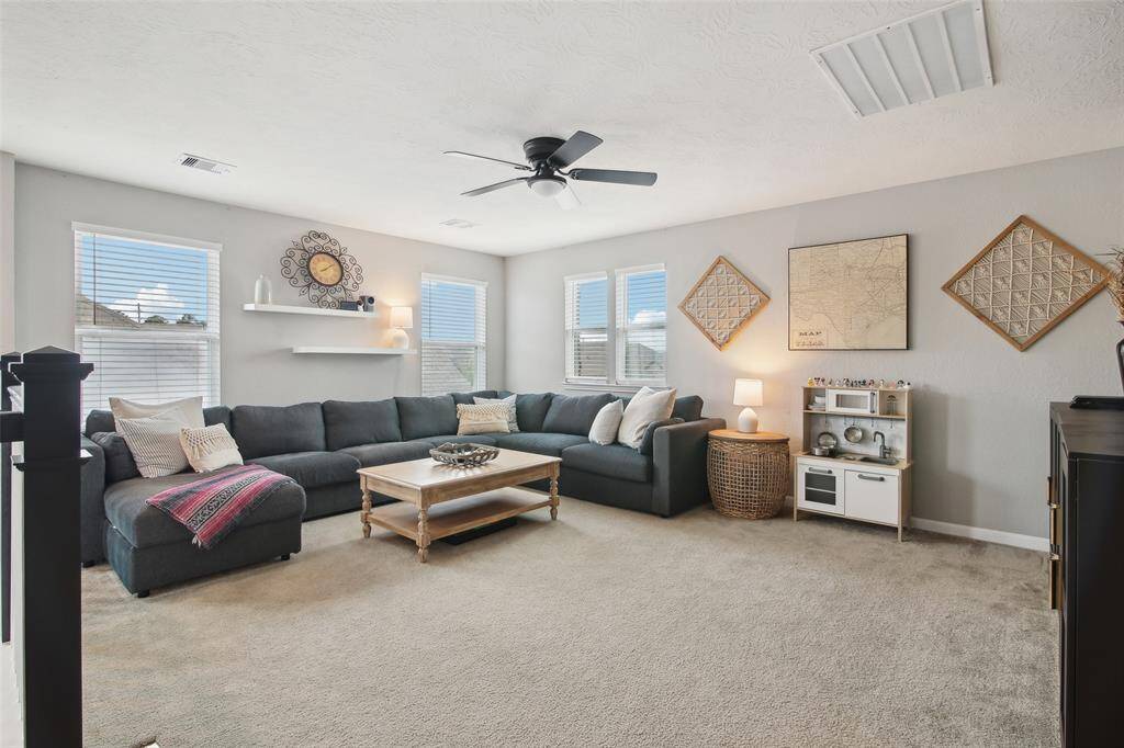 Additionally, an attic storage area provides extra room to keep seasonal items and belongings neatly tucked away.