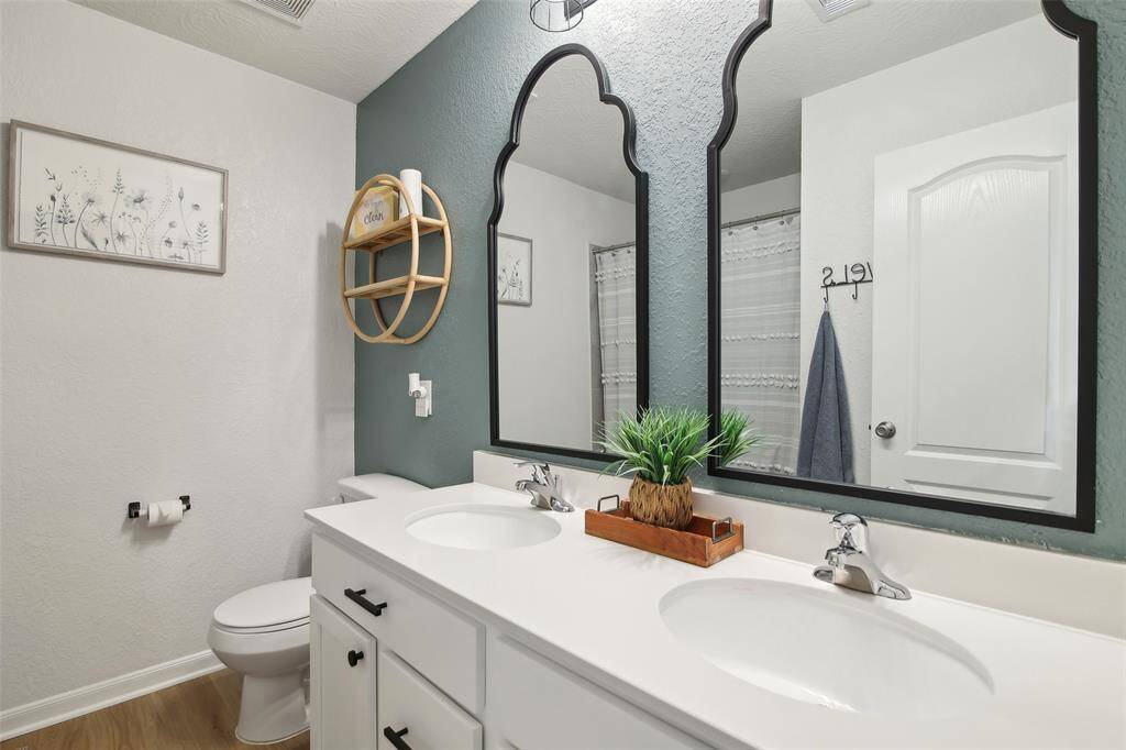 Upstairs bathroom with double vanities and a shower/tub combination.