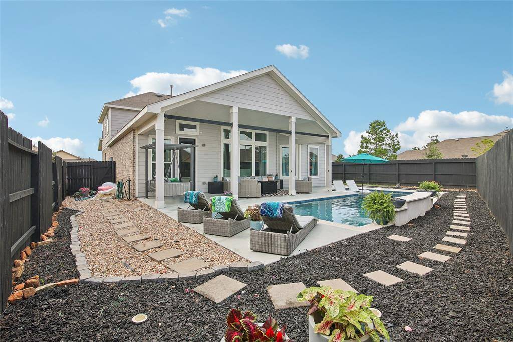 The backyard is thoughtfully designed to flow seamlessly from indoor living spaces, making entertaining effortless.