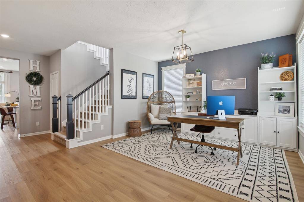 o the right, the formal dining area is currently being used as a home office, offering flexibility to suit your lifestyle.