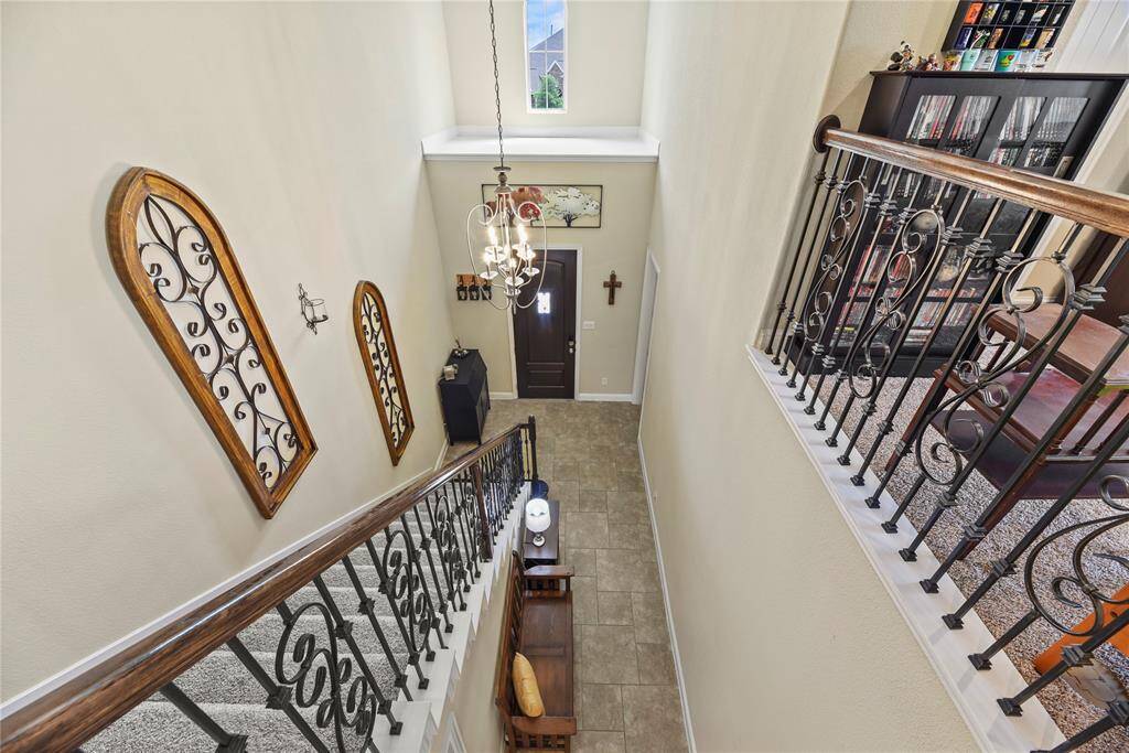 Two story entry with beautiful iron and wood details.