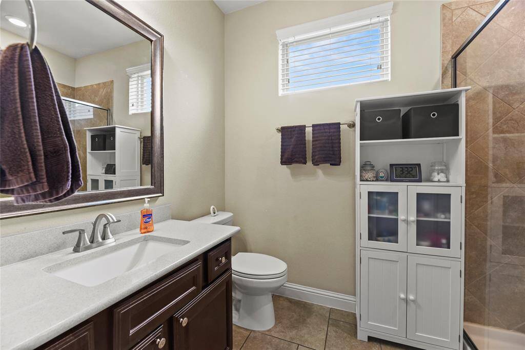 Well-equipped bathroom with natural light, undermount sink, framed mirror.....
