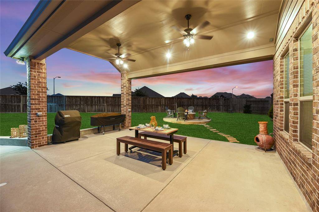 Extended covered patio with 2 ceiling fans, extra lighting and a gas stub! It's ready for your next party!