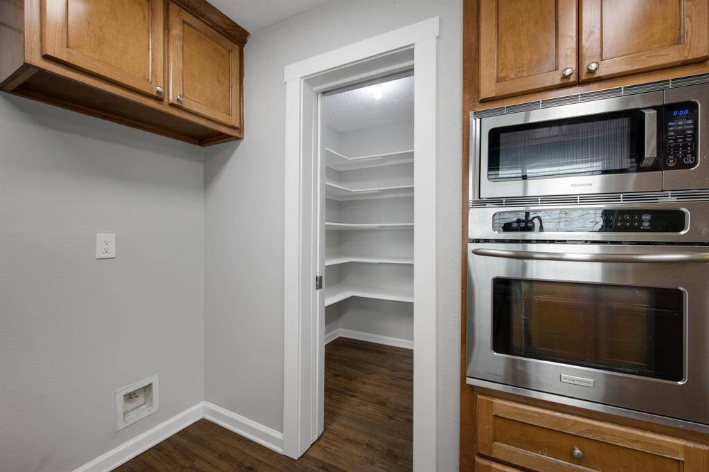 The kitchen includes a spacious walk-in pantry, providing plenty of organized storage for groceries and kitchen essentials.