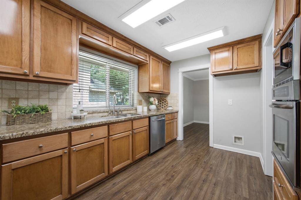 The kitchen showcases newer custom cabinets, offering ample storage with a personalized, high-quality finish.