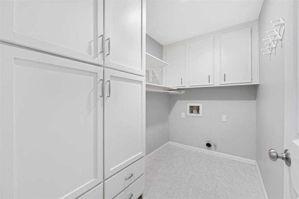 The utility room is spacious and includes plenty of storage space to keep essentials organized and easily accessible.