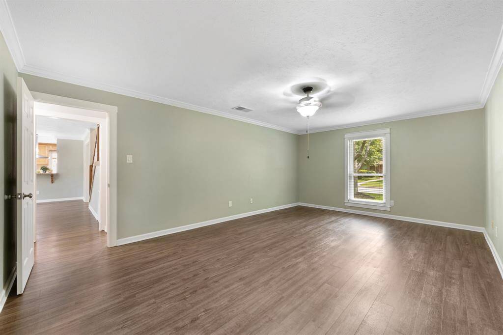 A front-facing window with blinds lets in natural light, while a ceiling fan ensures comfort year-round.