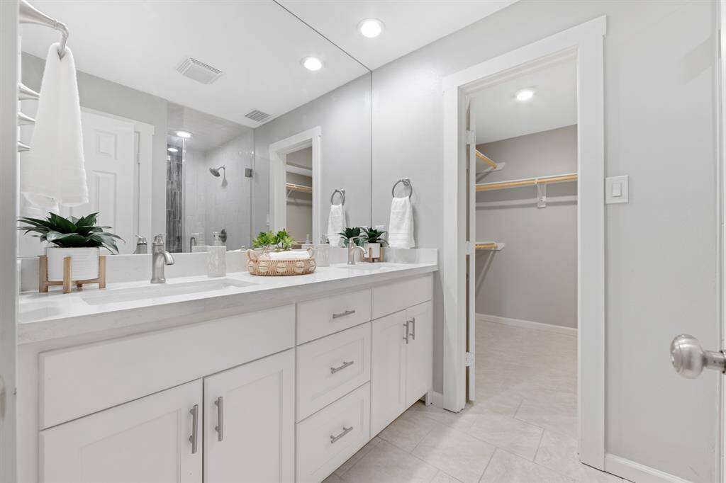 The primary bathroom boasts granite countertops and a large shower, remodeled in 2021 for a fresh, modern feel.
