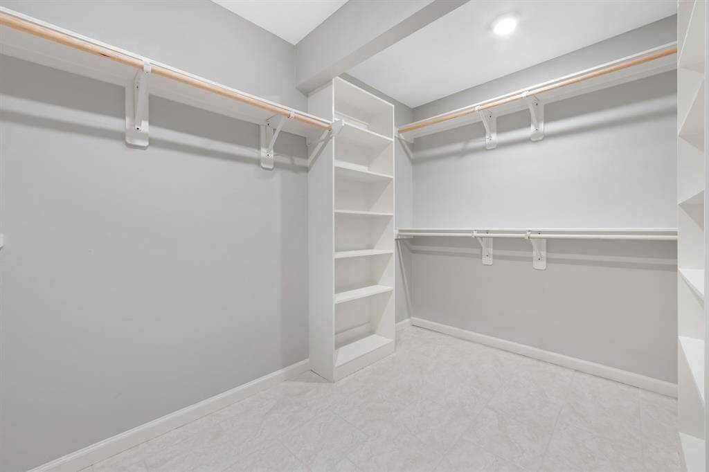 A large primary closet offers ample storage and organization space.