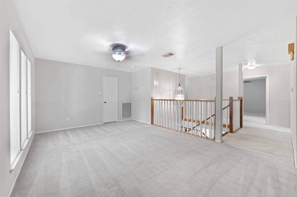The game room includes a convenient closet, a ceiling fan, and front-facing windows with mini blinds.This versatile space is perfect for entertainment, sports, or a cozy retreat.
