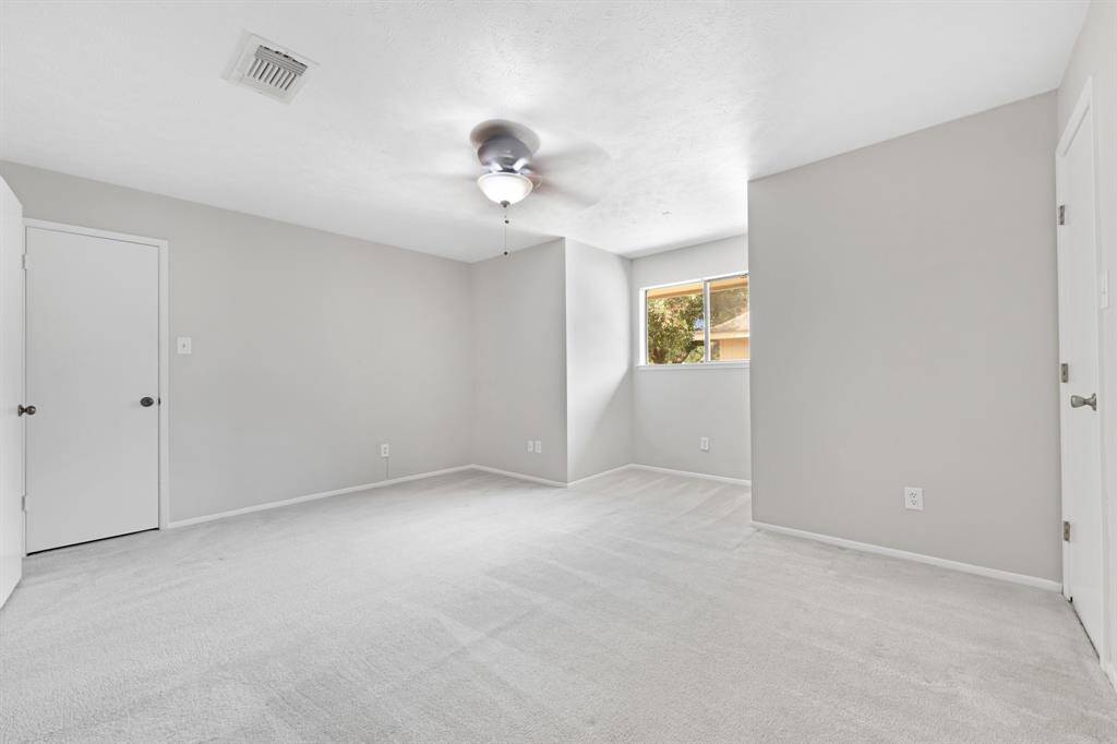 The three upstairs bedrooms feature soft carpet flooring, each with its own ceiling fan for comfort.All bedrooms include walk-in closets, offering plenty of storage space.