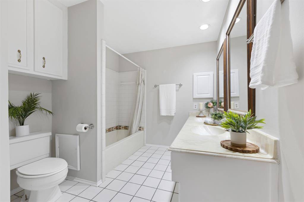 The shared bathroom upstairs includes dual sinks, providing convenience and comfort.