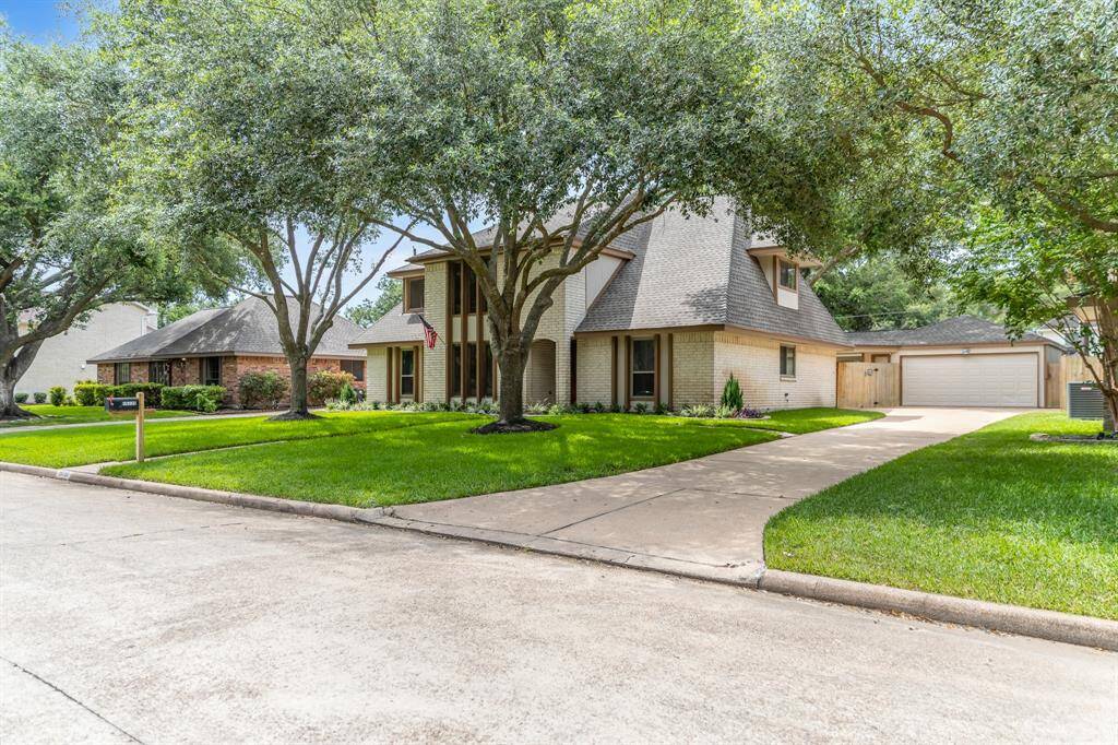 Featuring a newer garage door and spacious entrance, this home offers a warm and inviting curb appeal.