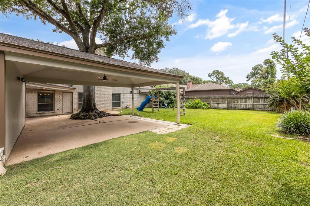 The backyard offers lush greenery, creating a spacious area that's perfect for pets and kids to play.