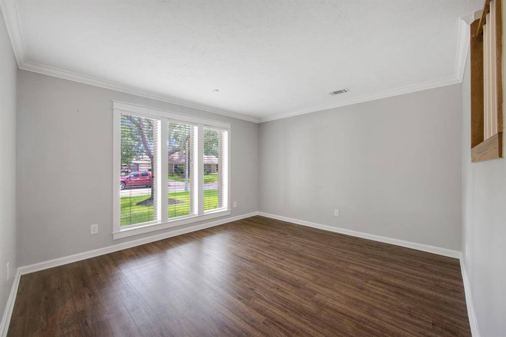 The formal living room, situated to the left of the entry, is perfect for entertaining or relaxing.It features beautiful LVP flooring and a tall window for plenty of natural light.