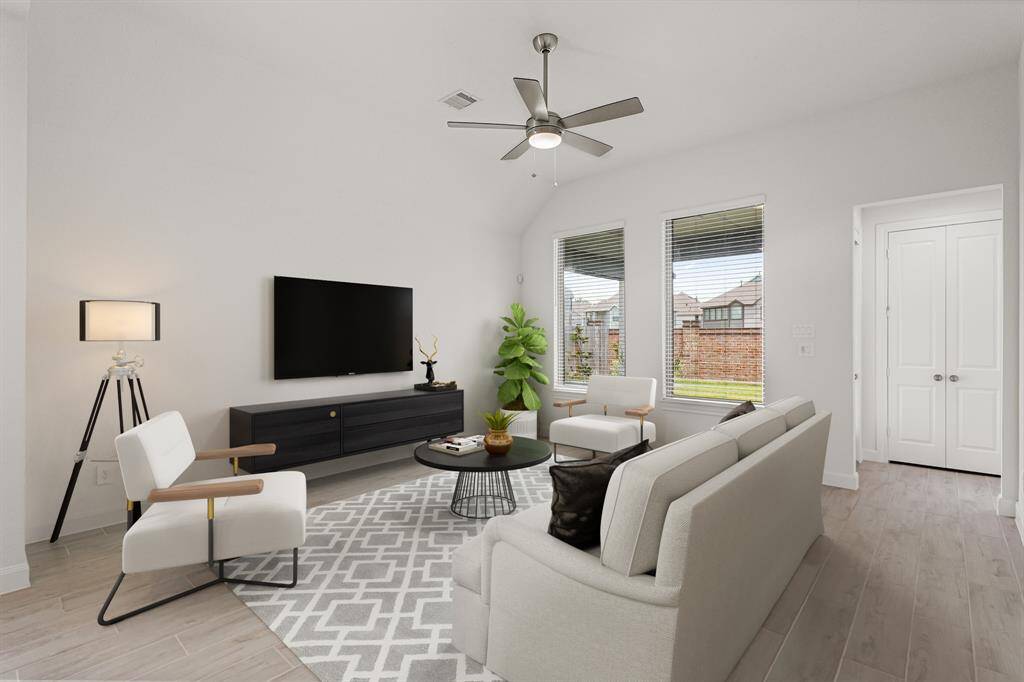 Virtually Staged: Stunning living room with a ceiling fan, and windows with views into your backyard.