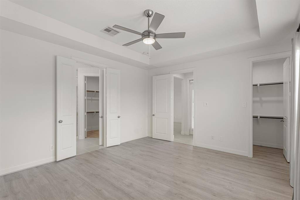 Another angle of this bedroom showcases how spacious this room is. It is complete with 2 walk-in closets, and ensuite bathroom.