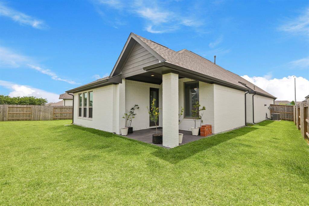There is solid board fencing on the sides of the home.