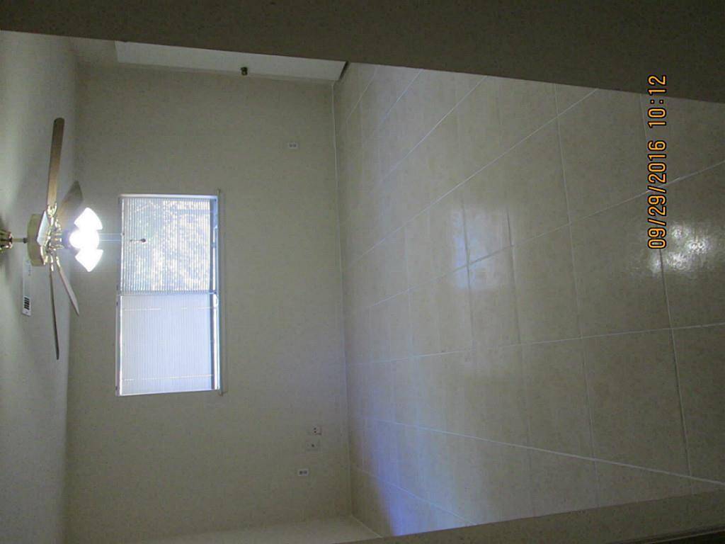 Italian 18" tile in the master bedroom looks very shiny! Nice fan in master also.