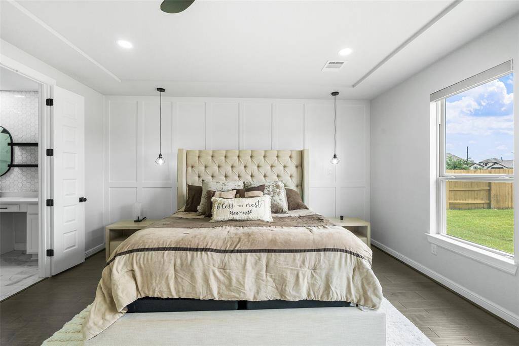 Retreat to a huge primary bedroom featuring motorized shades for effortless comfort and privacy at the touch of a button.