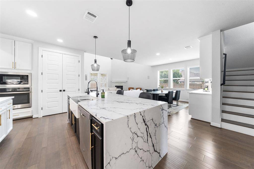 Experience modern living in this beautifully designed open-concept home, where a sleek kitchen flows seamlessly into a spacious family room—perfect for entertaining and everyday comfort."