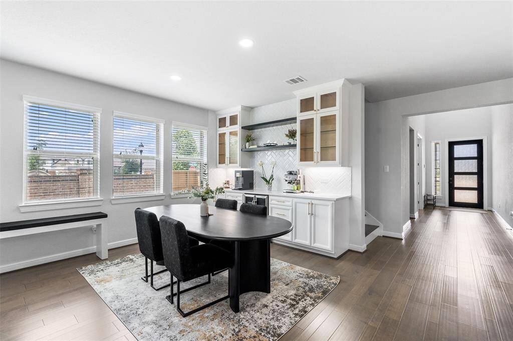 This elegant former model home features a formal dining room with custom built-ins and is loaded with premium upgrades and designer extras throughout.