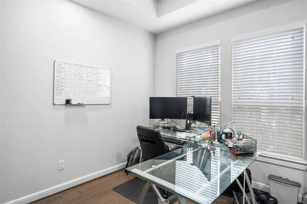 Work from home in style in the private office, featuring elegant French doors and abundant natural sunlight.