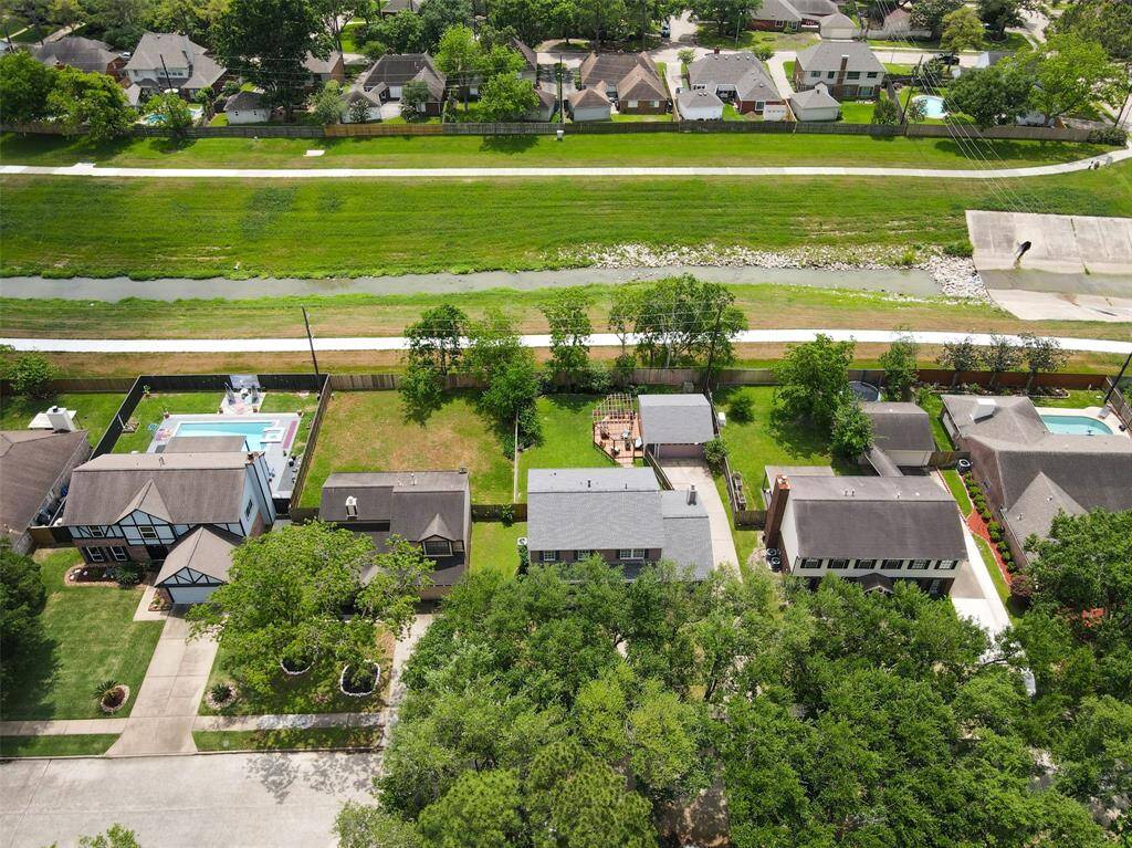 Another aerial view of the backyard of this inviting home nestled among lush green space and neighborhood walking trail.