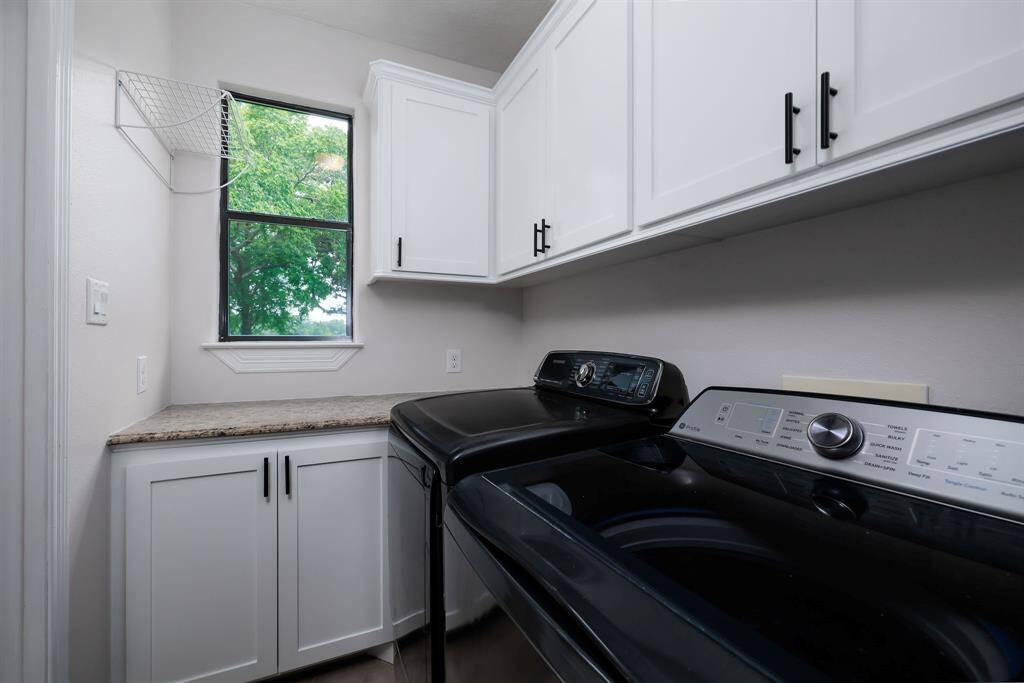Utility/Laundry room has pleny of cabinet space.