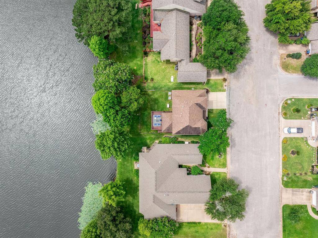 Overhead view shows the home right on the water and beautiful trees on the shore.
