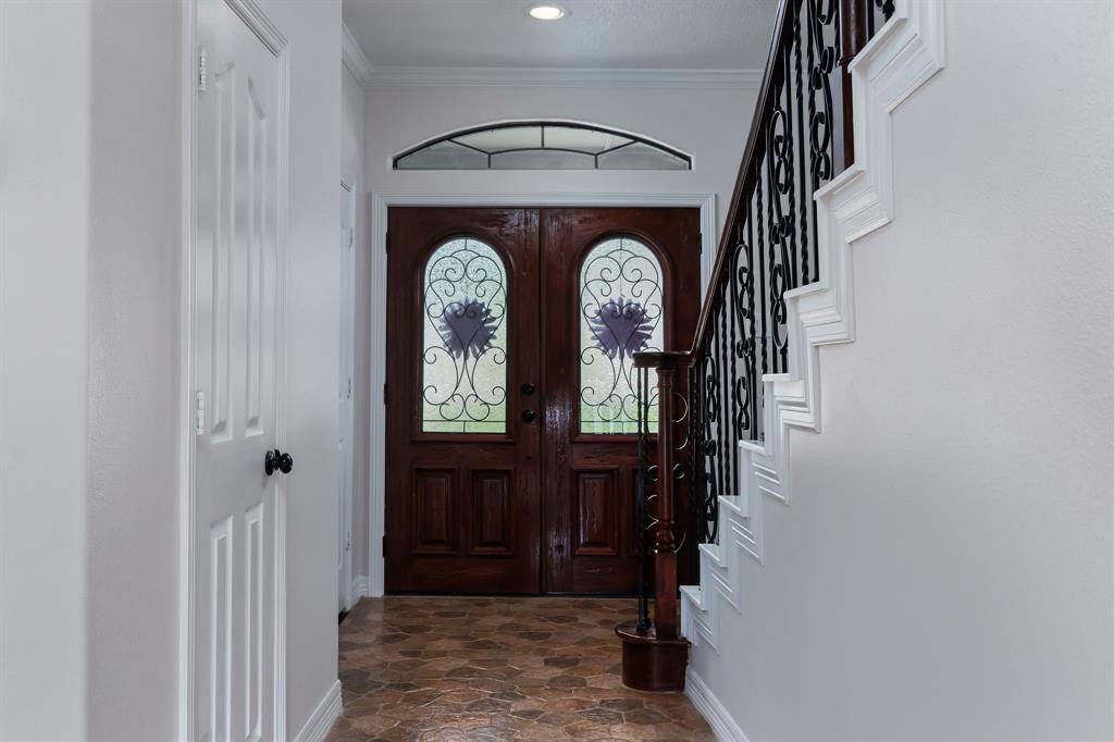 Custom double doors lead into the home/foyer.