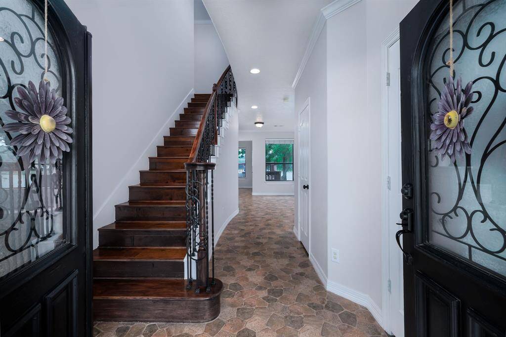 Looking into the home/foyer and custom staircase from the front entrance.