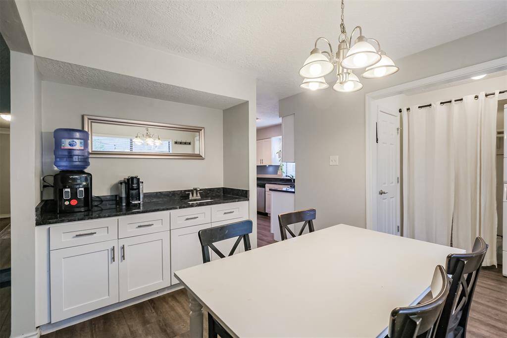Heading towards kitchen we step into the dining area with a wet bar.