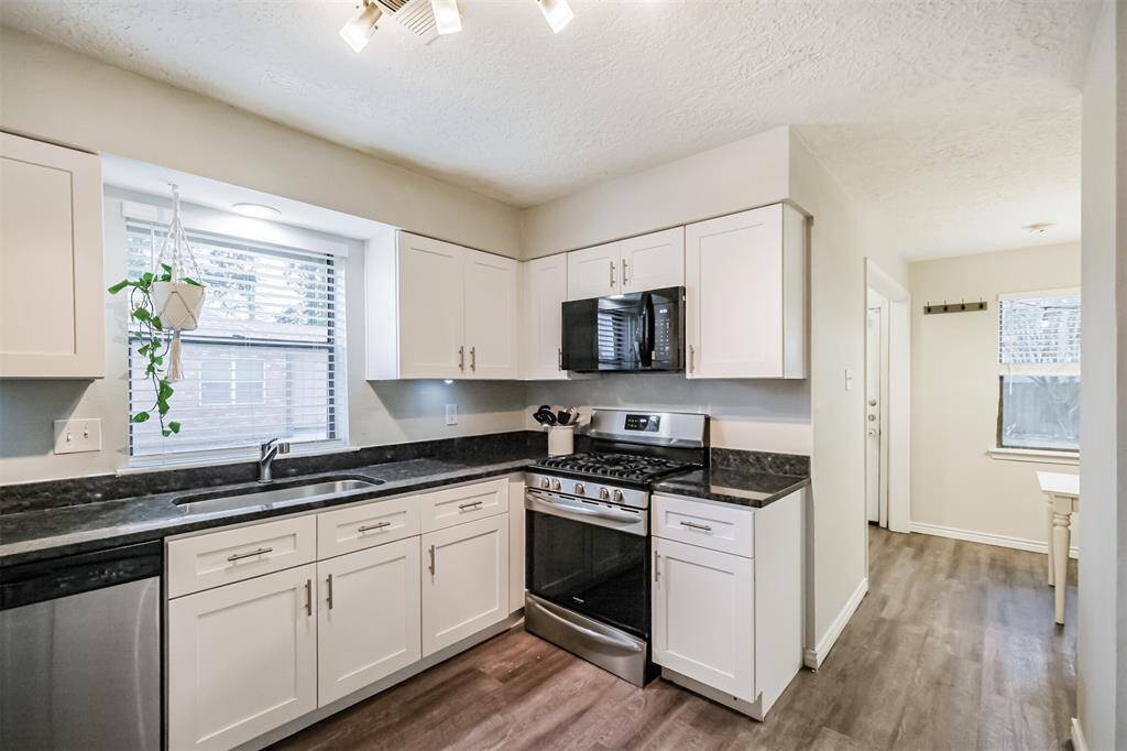 Standing in the kitchen this angle shows you the double wide stainless steel sink, that compliments the other stainless steel appliances.