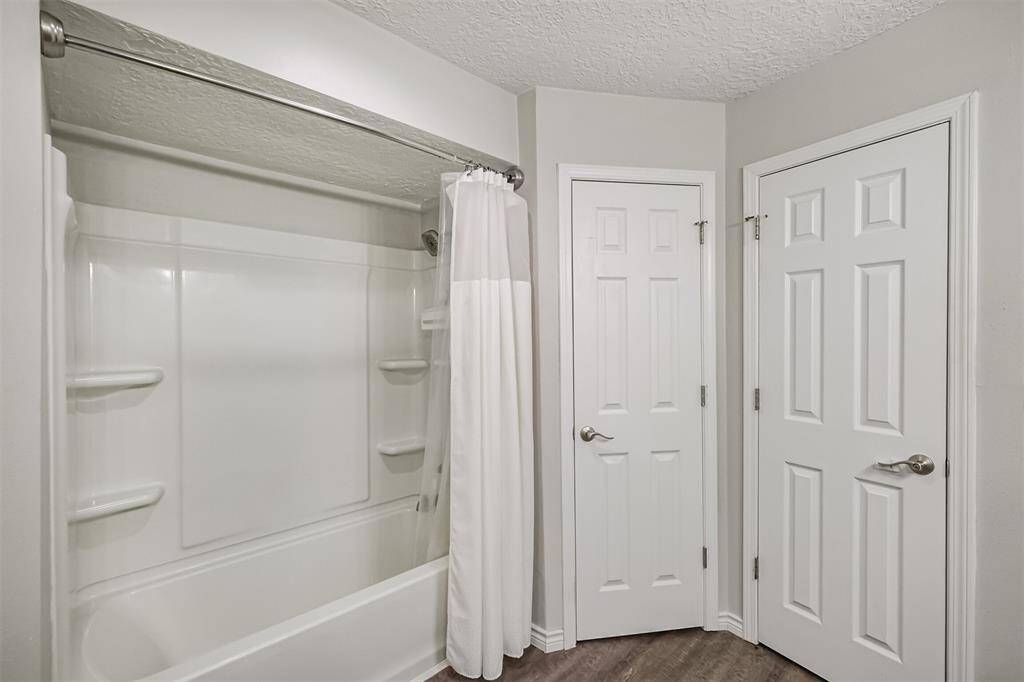 Turning 90 degrees we have the tub-shower combo and, again, the primary walk-in closet.