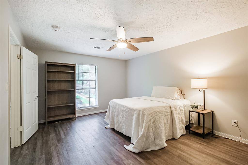 Just off the stairs is another bedroom. Generously size this could serve as a secondary primary bedroom.
