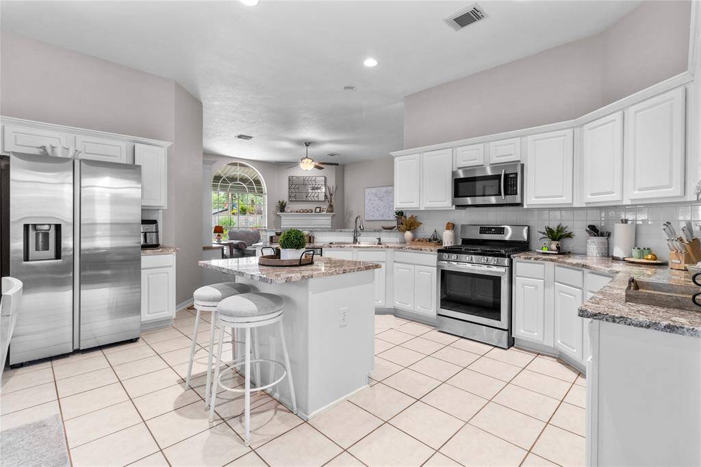 Remodeled kitchen is beautifully done with gorgeous granite, matching stainless steel appliances and tons of counter space and no shortage on cabinets