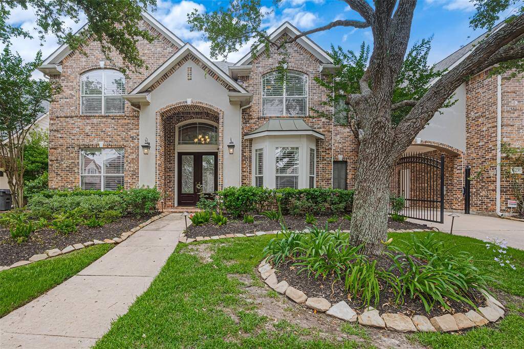 Stunning curb appeal welcomes you to this beautifully maintained two-story brick and stucco home located in the heart of Sugar Land